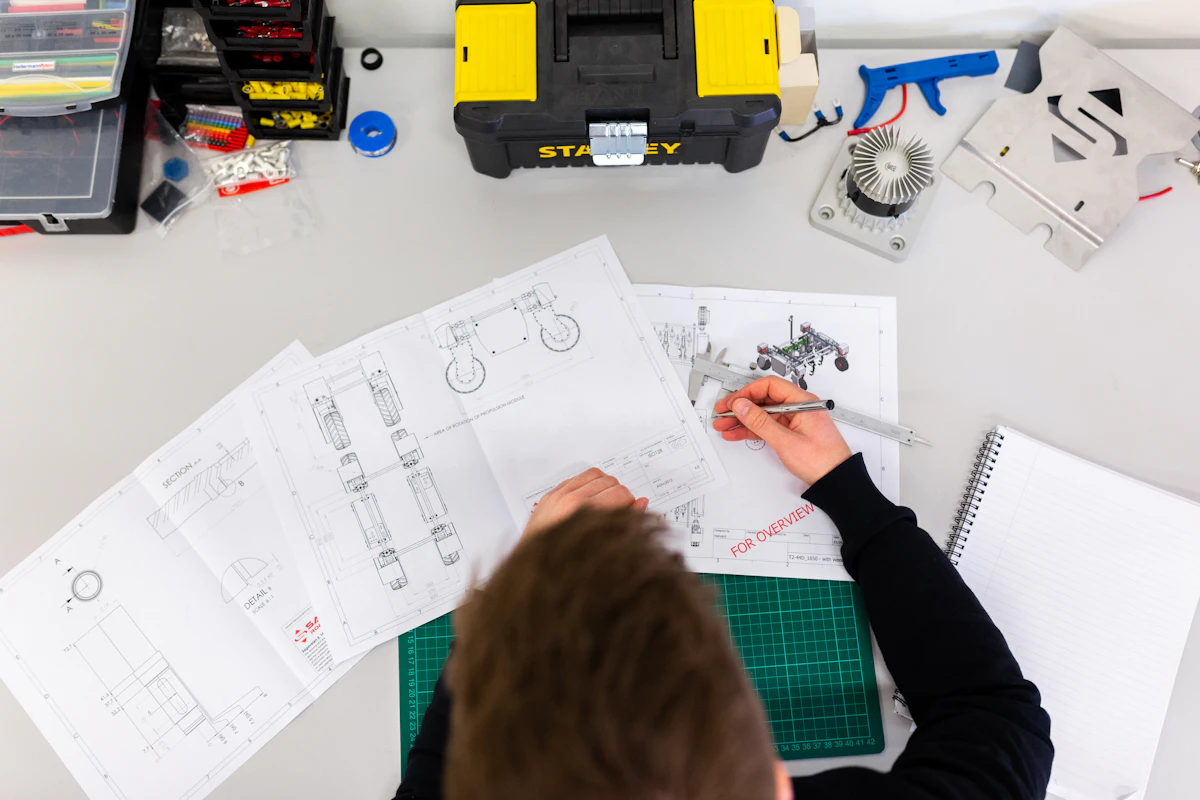 Engineer measuring technical drawings for a custom SCADA design