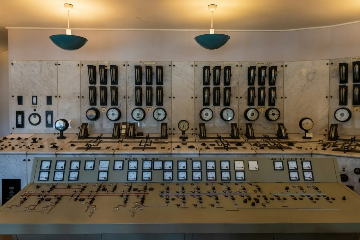 Plant control room lined with control panels and switches