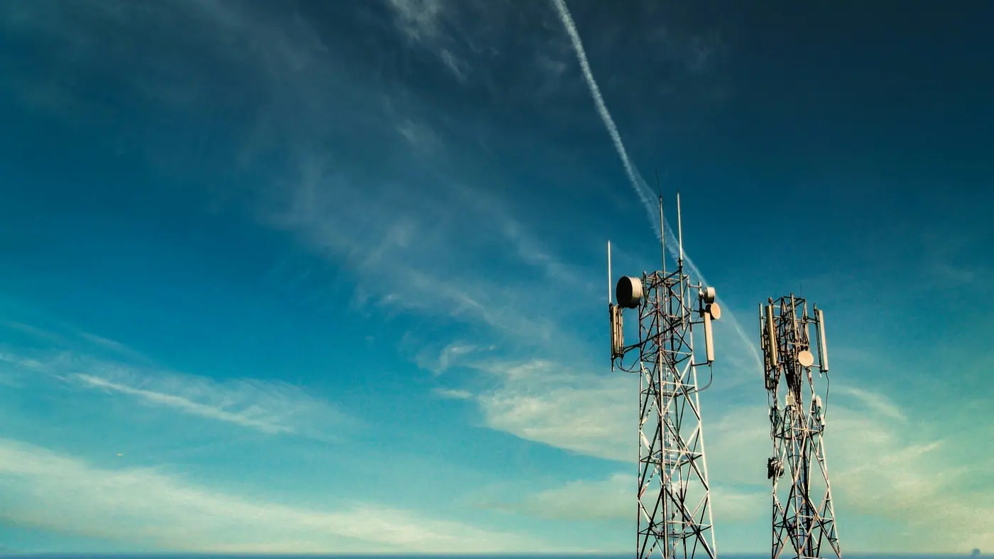 Mobile network transmission tower against a blue sky